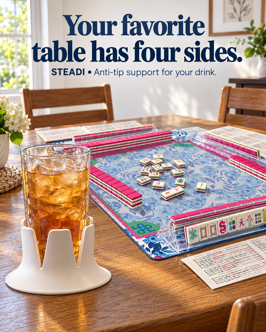 White Steadi supporting a tall iced-tea glass beside a Mahjong mat, tile racks and a reference card. Illustrative AI-generated scene.
